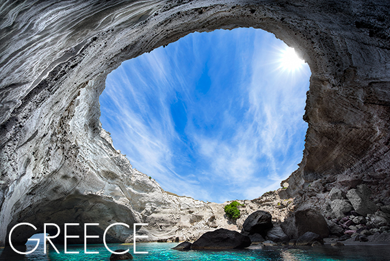 Sea cave opening to the sky in Milos, Greece by Chris Petsos