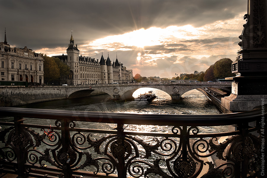 Chris Petsos photo of Paris as the sun bursts out of clouds over the River Seine