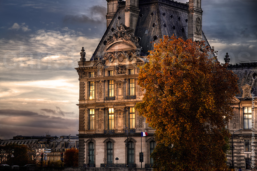 Christopher Petsos photo of sunset reflected on the windows of the Louvre with a tree in Autumn