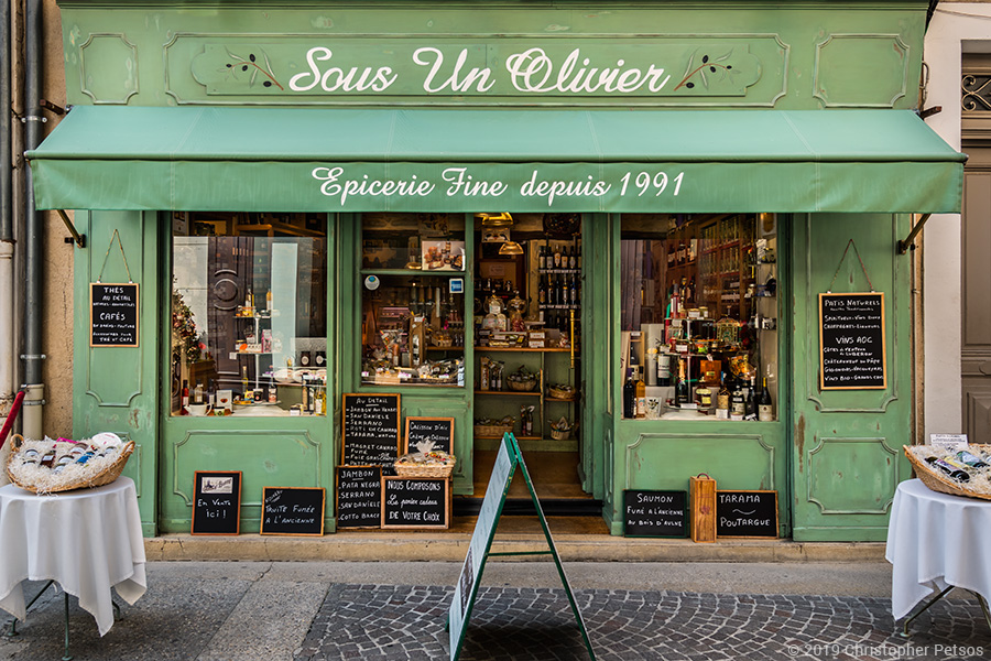 Epicerie with olive green storefront in Isle sur la Sorgue