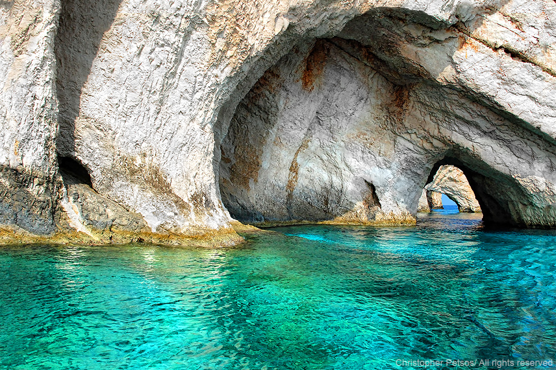 white rock and stone caves with clear turquoise water