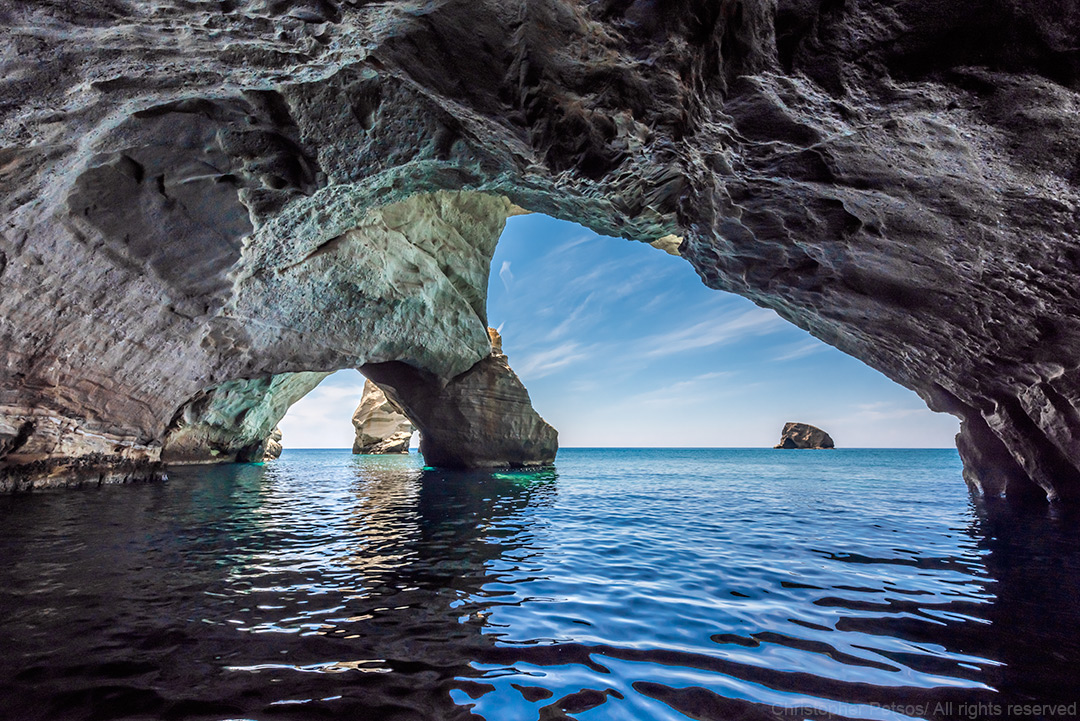 Sea caves and rock formations with water and blue sky