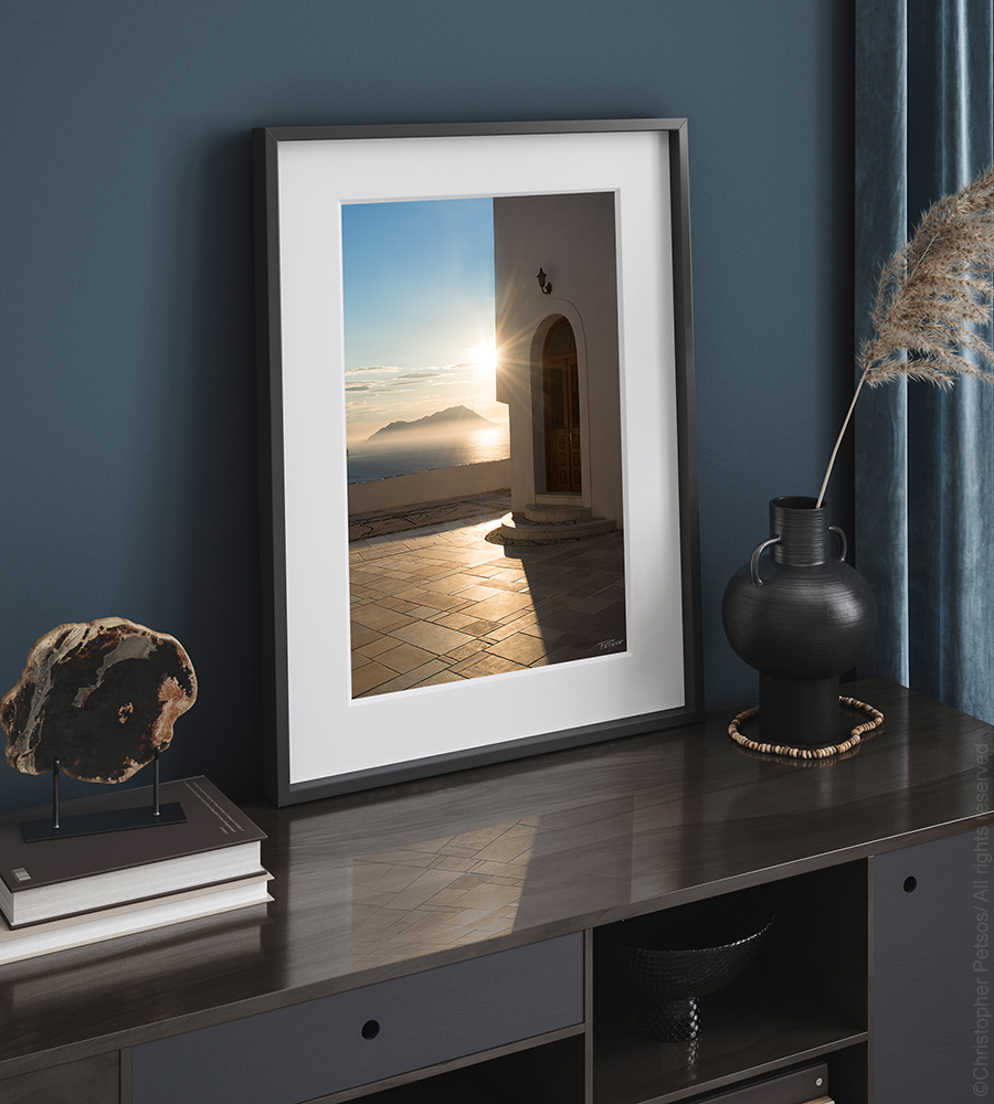 Photography print by Christopher Petsos of Milos in Greece, framed and displayed on a credenza.