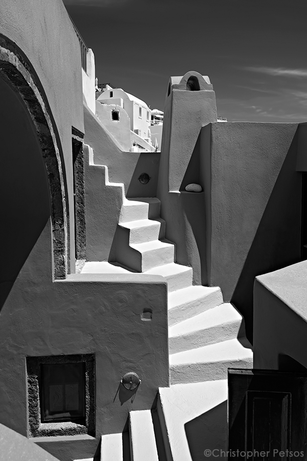Christopher Petsos fine art black and white photography print of Santorini, Greece architecture with white stairs creating a cubist composition.