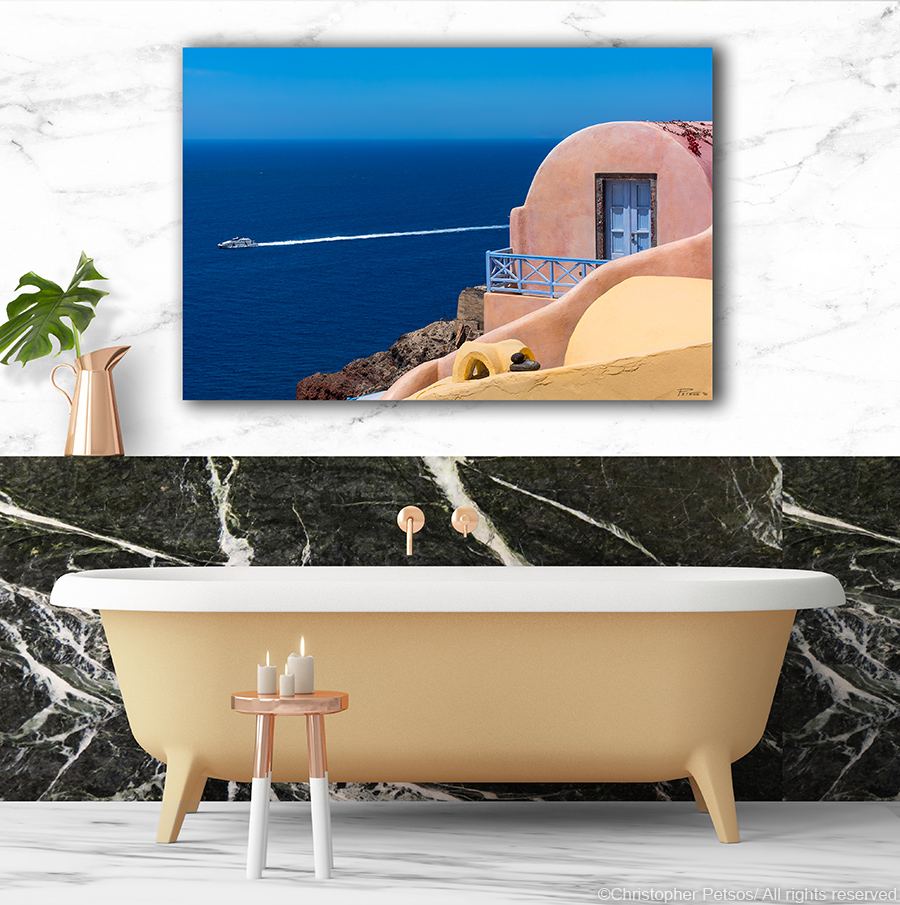 Print of Santorini Greece by Chris Petsos displayed in a marble bathroom