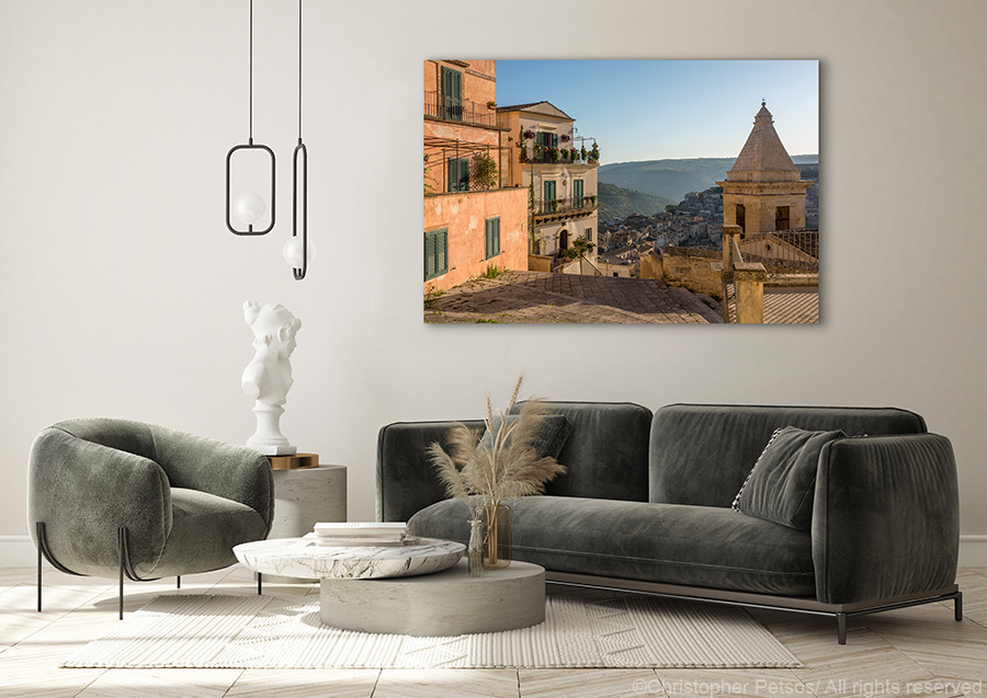 Print of Ragusa Sicily by Christopher PEtsos hanging above a modern sofa set