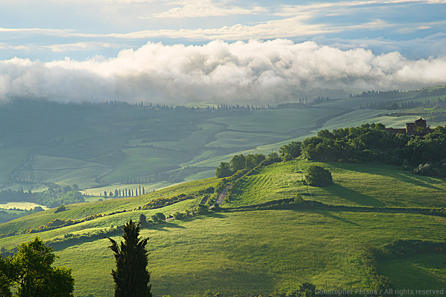 Green hills and sky with fog and clouds in Val d'Orcia Tuscany