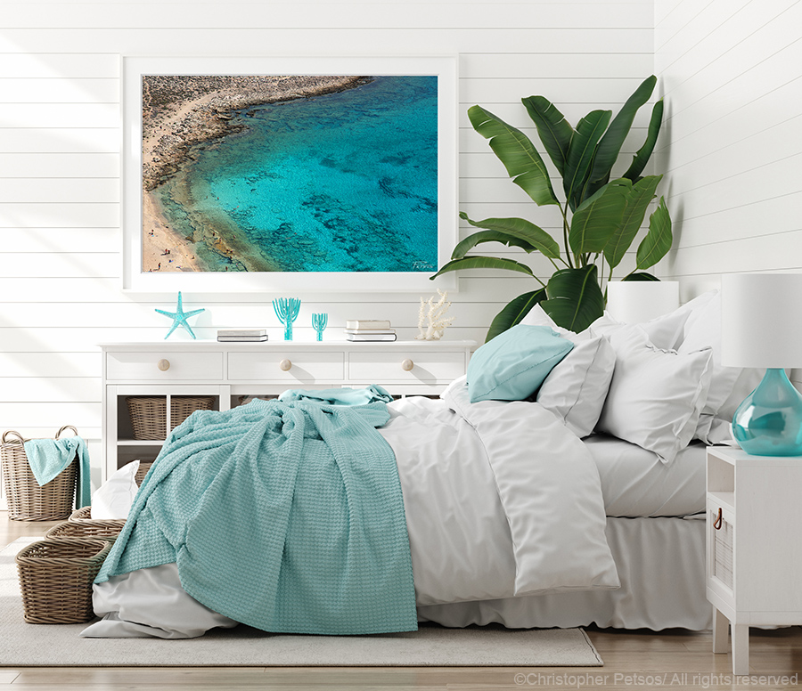 Seascape print by Christopher Petsos hanging in a coastal themed bedroom