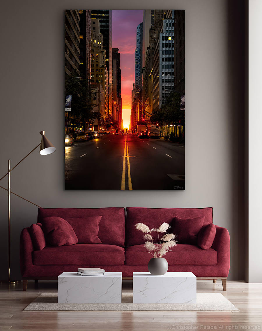 print of Manhattanhenge taken by Christopher Petsos hanging above a burgundy colored sofa