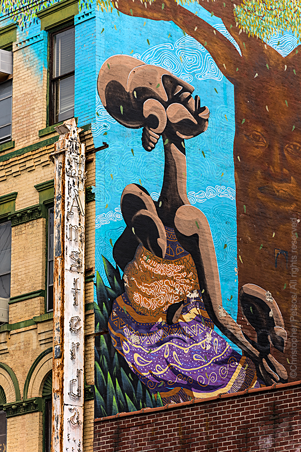 The old Amsterdam News building in Harlem with an afrocentric mural painted on the side of it