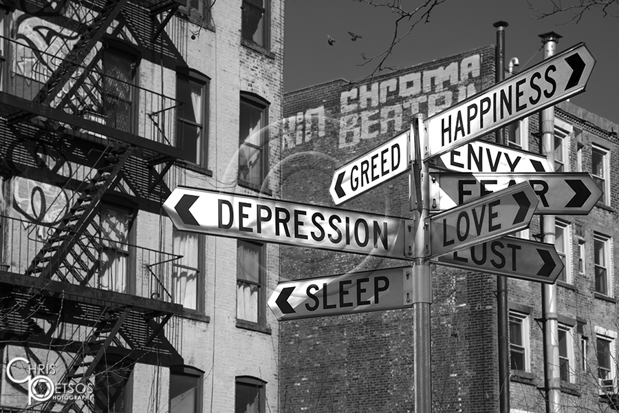 New York street signs with emotions instead of street names and typical tenement buildings in the background